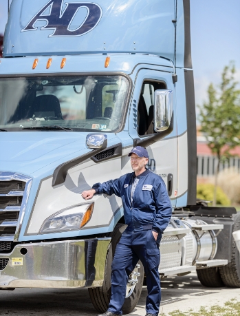 driver standing beside his truck