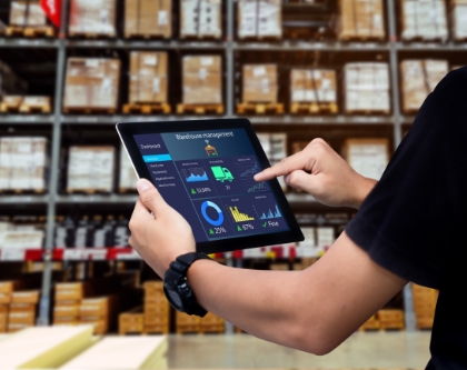 employee touching ipad that have graphs on it